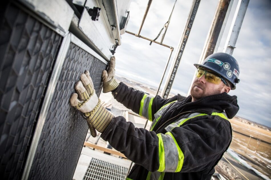 Technician working on an exterior HVAC panel
