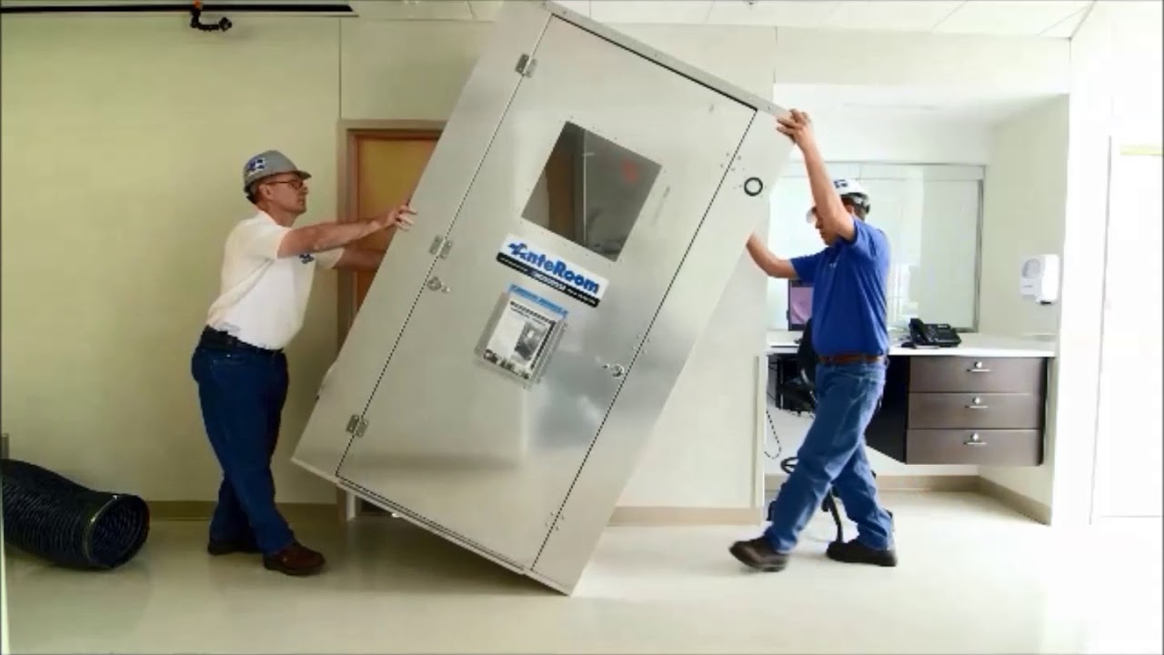 Two men moving equipment